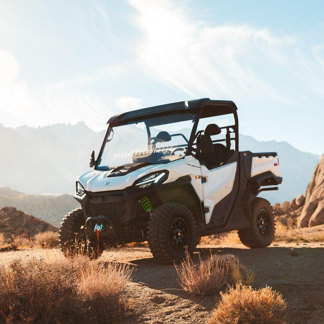 VLCN HF1 side by side front profile image in desert showing accessories such as winch and suspension